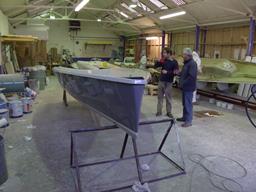Simon Hipkin and Andy Ladds of BlueMotion Yachts Ltd inspect the first boat off the mould at White Formula, Brightlingsea, Essex, 7 January 2014 